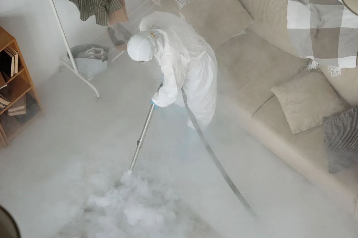 Biohazard cleanup technician in protective equipment, Fall River, MA